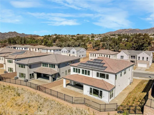 an aerial view of a large building with a big yard