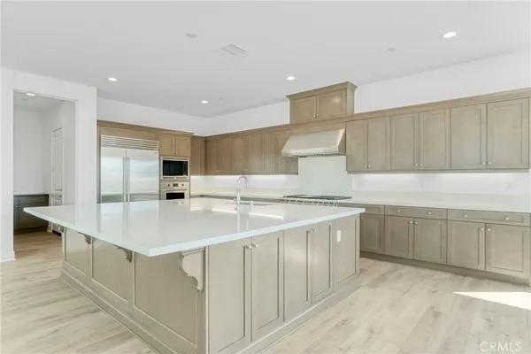 a large white kitchen with cabinets