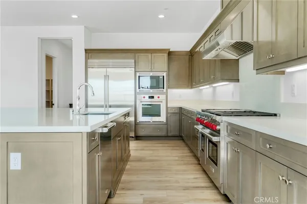 a kitchen with stainless steel appliances granite countertop a stove and a refrigerator