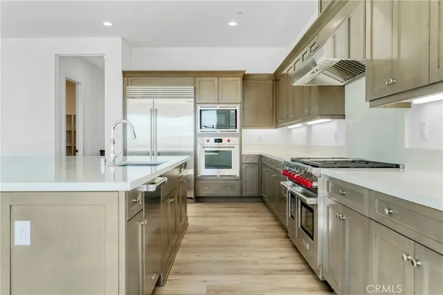 a kitchen with stainless steel appliances granite countertop a stove and a refrigerator