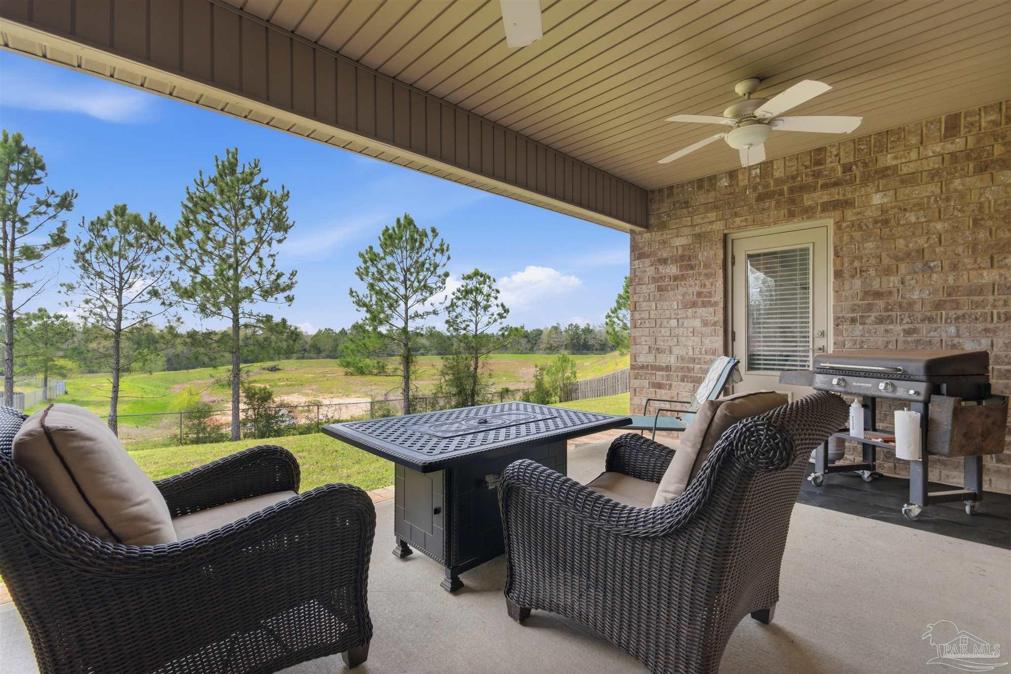 2677 Tulip Hill Road Pace, FL 32571 - Photo 33 of 35 a balcony with furniture and garden view