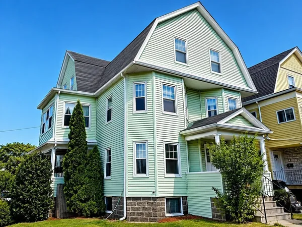 a front view of a house with plants