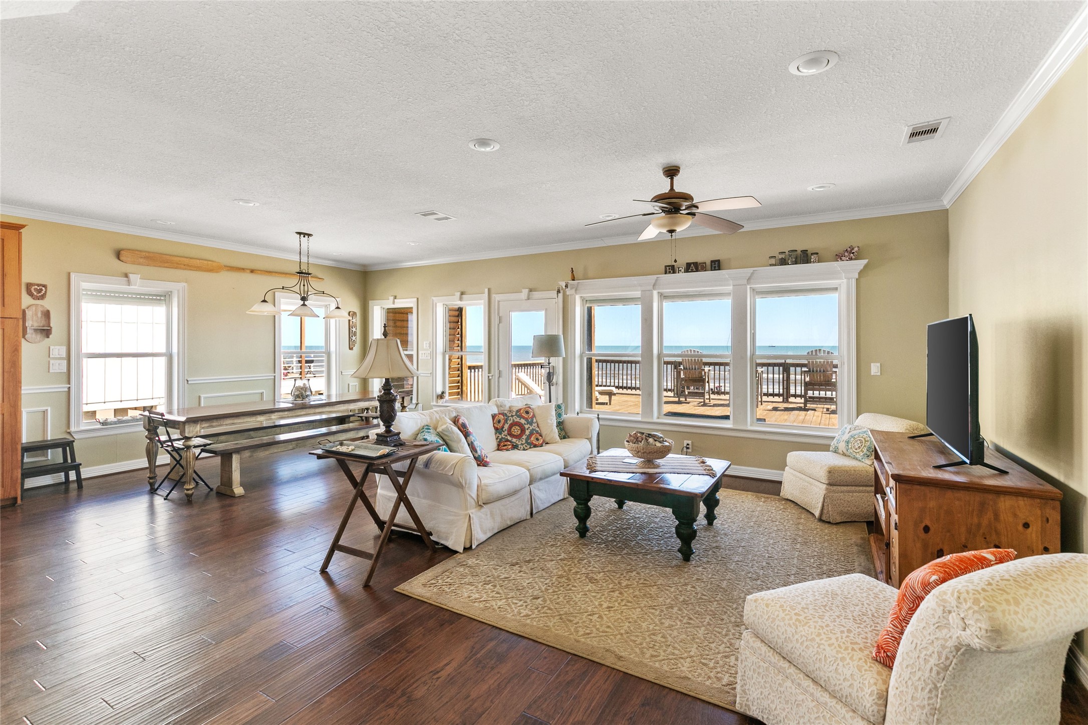 10530 Bluewater Highway Freeport, TX 77541 - Photo 11 of 43 a living room with furniture and a flat screen tv with wooden floor