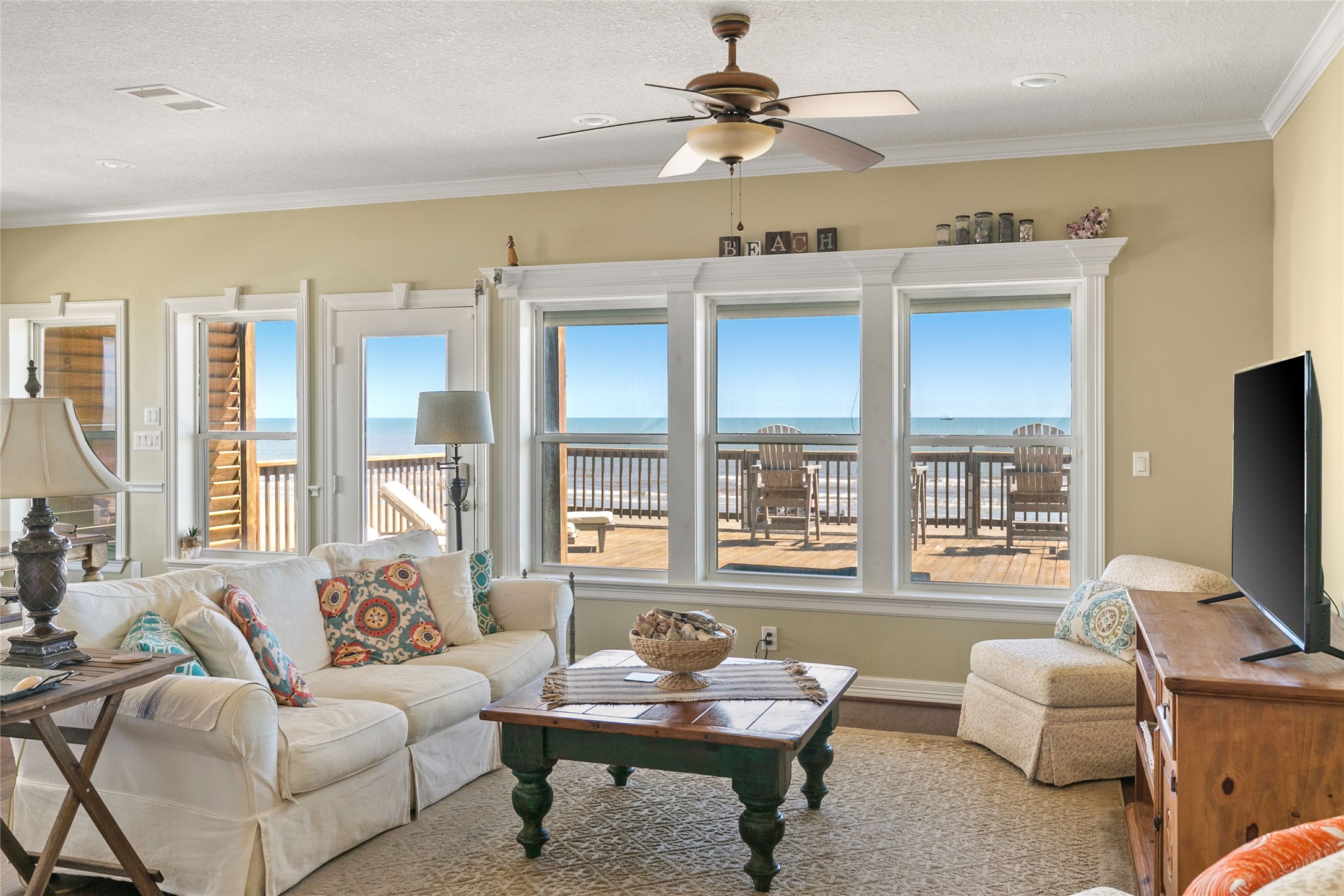 10530 Bluewater Highway Freeport, TX 77541 - Photo 12 of 43 a living room with furniture a flat screen tv and a large window