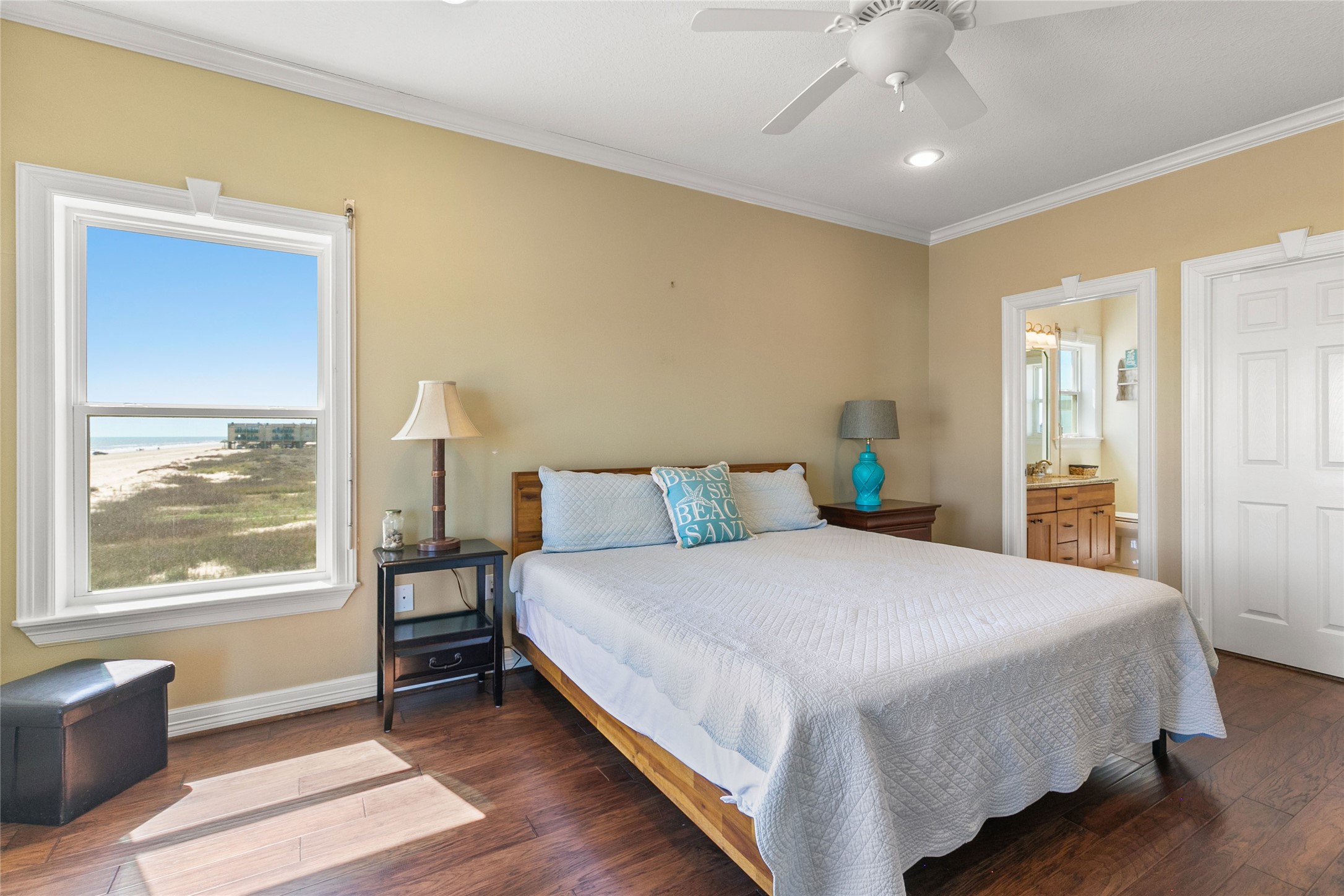 10530 Bluewater Highway Freeport, TX 77541 - Photo 21 of 43 a bedroom with a large bed and a chandelier