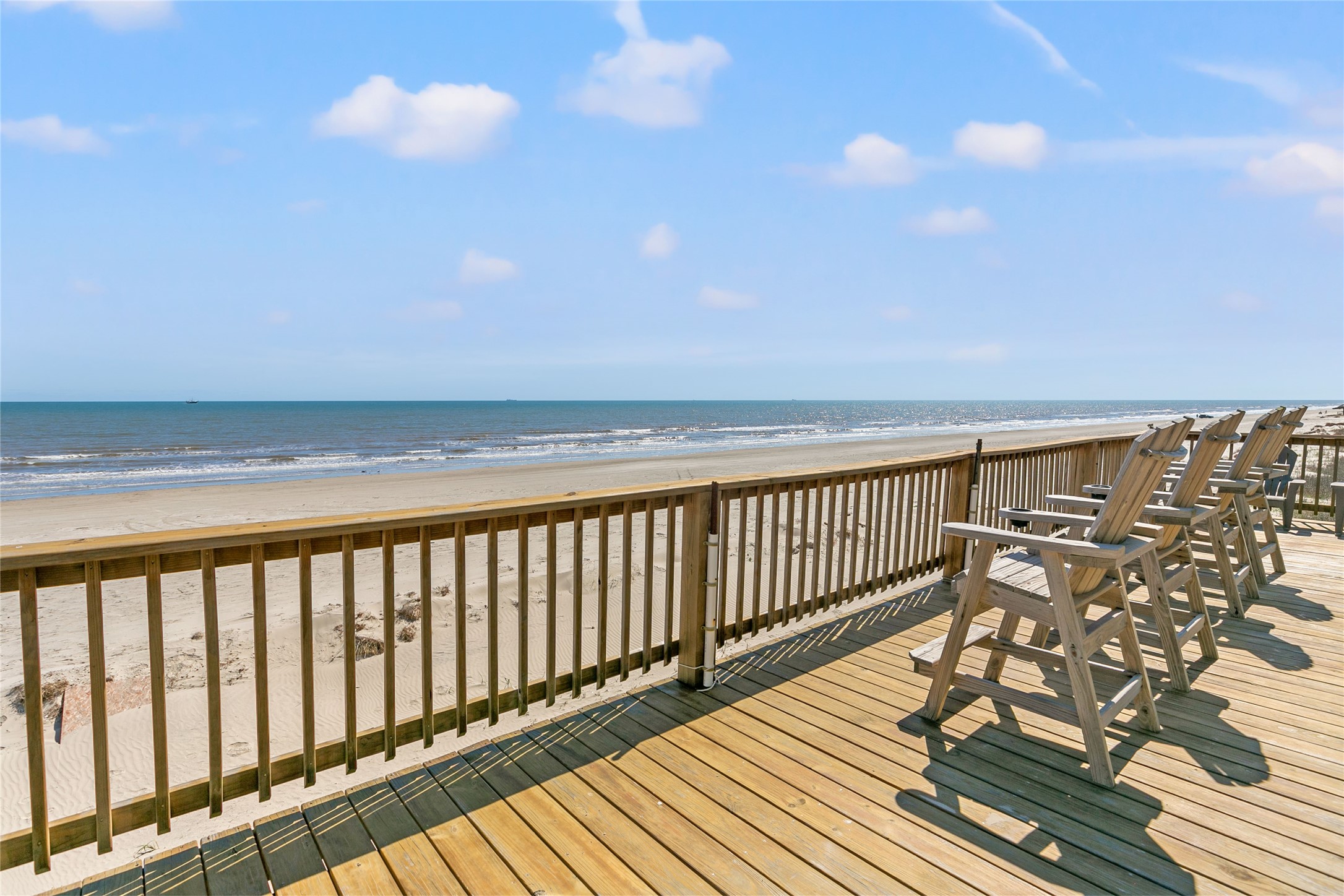 10530 Bluewater Highway Freeport, TX 77541 - Photo 24 of 43 a balcony with wooden floor and fence