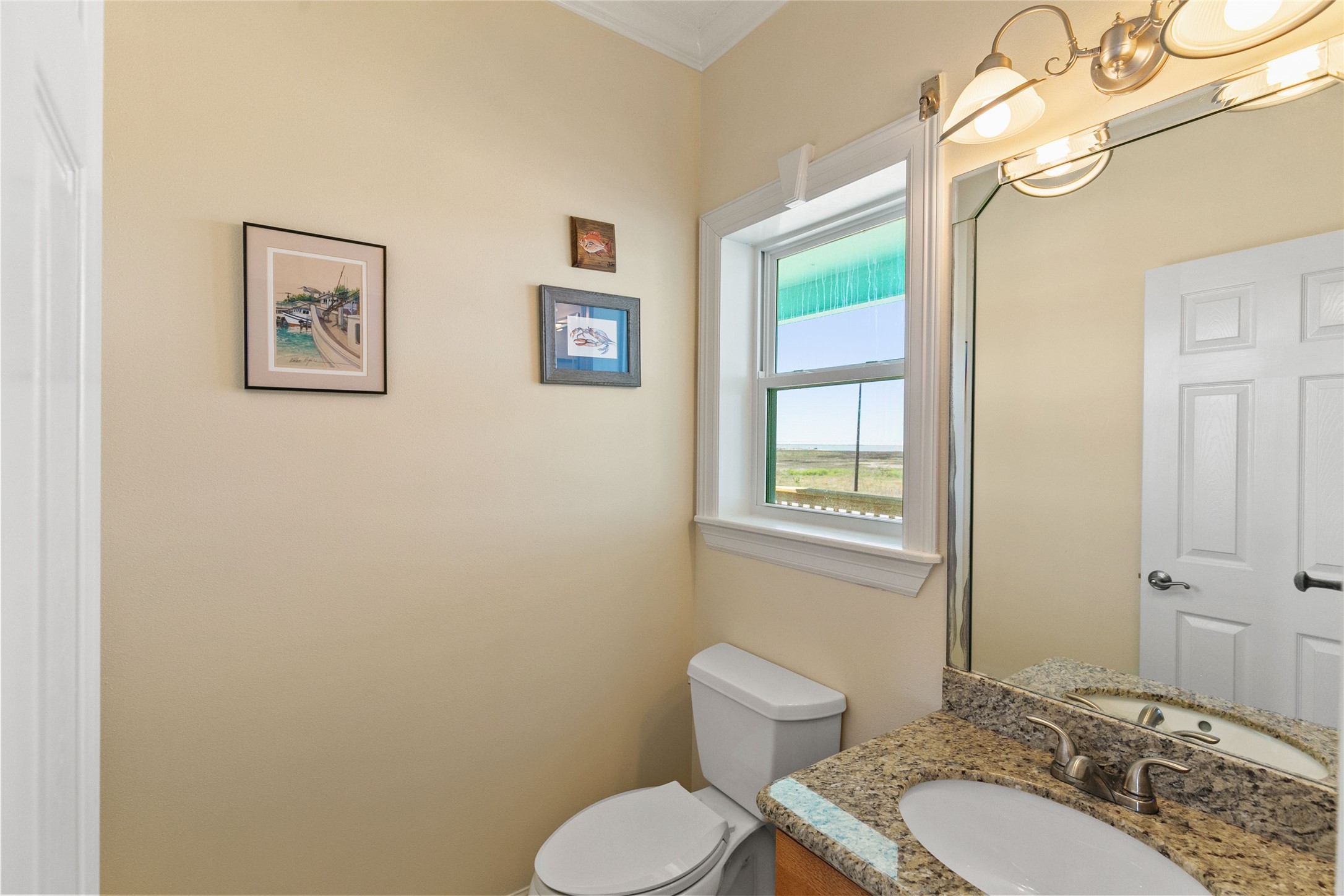 10530 Bluewater Highway Freeport, TX 77541 - Photo 26 of 43 a bathroom with a toilet a sink and mirror