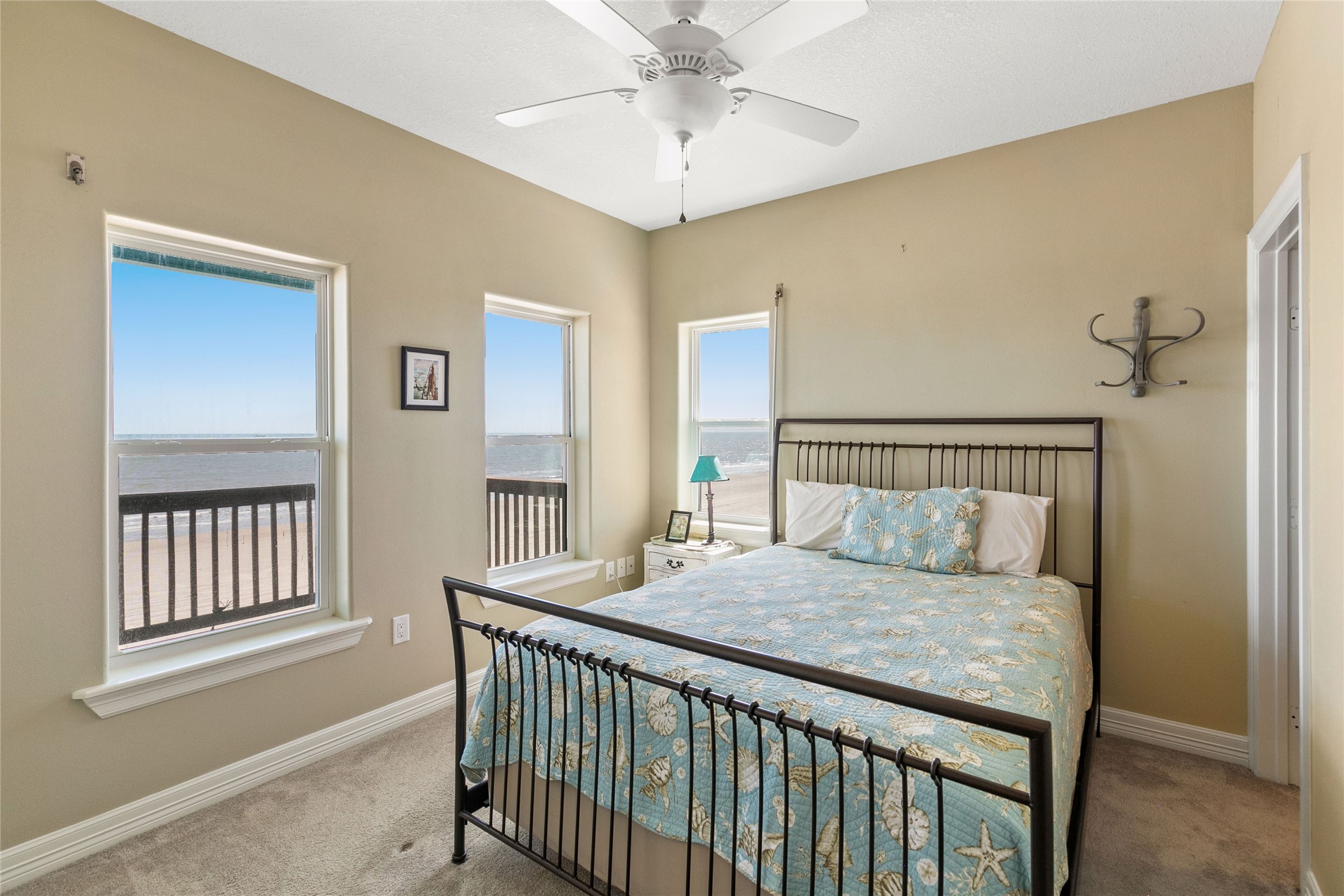 10530 Bluewater Highway Freeport, TX 77541 - Photo 30 of 43 a bedroom with a bed and a chandelier