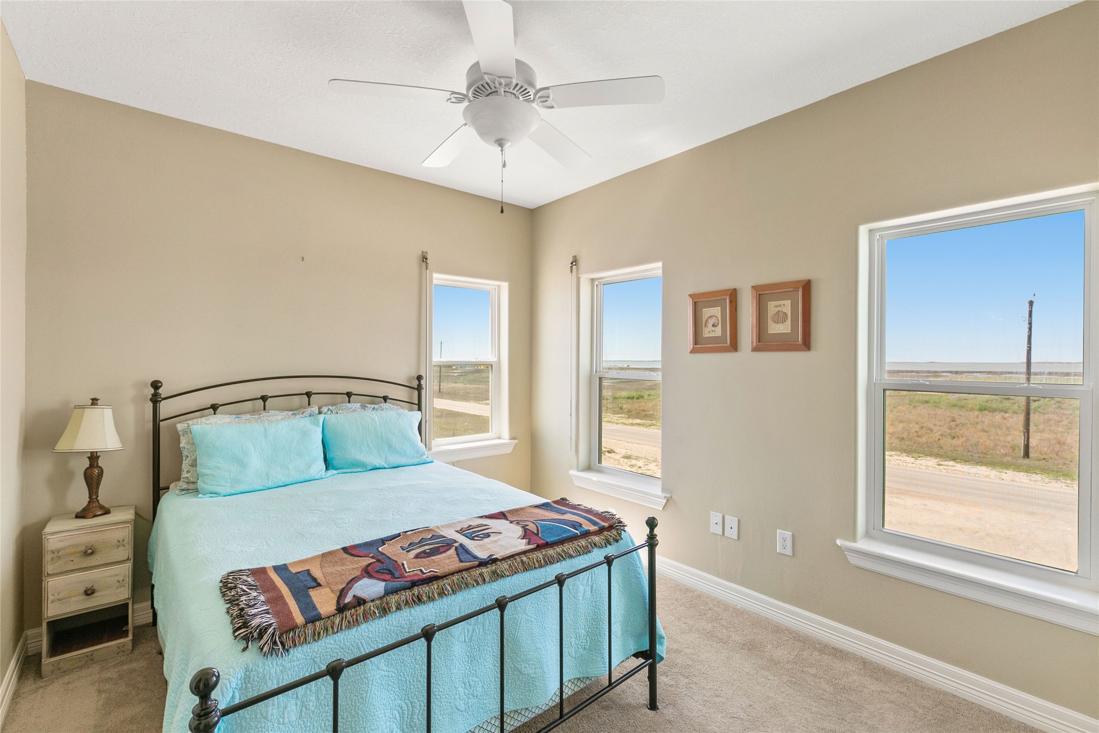 10530 Bluewater Highway Freeport, TX 77541 - Photo 32 of 43 a bedroom with a large bed and a window