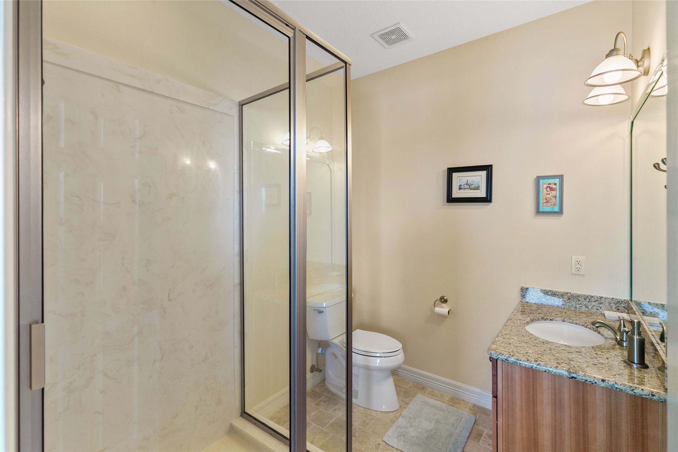 10530 Bluewater Highway Freeport, TX 77541 - Photo 33 of 43 a bathroom with a granite countertop sink toilet and shower