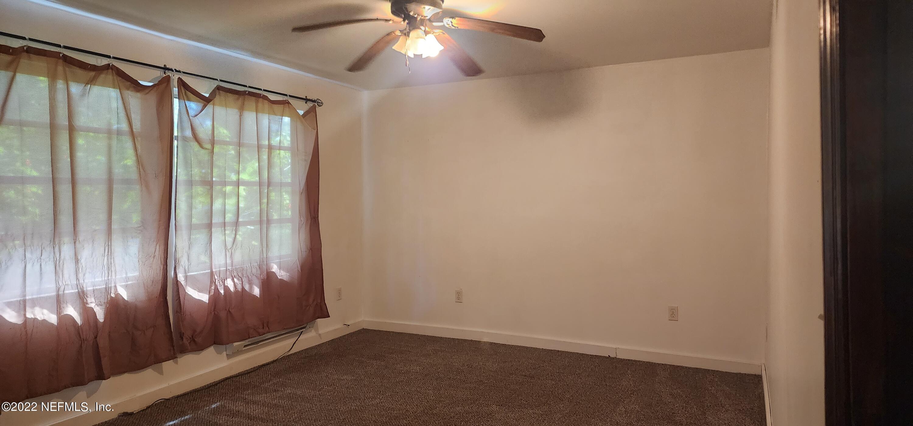 25035 Northeast 131st Place Salt Springs, FL 32134 - Photo 11 of 21 an empty room with wooden floor and windows