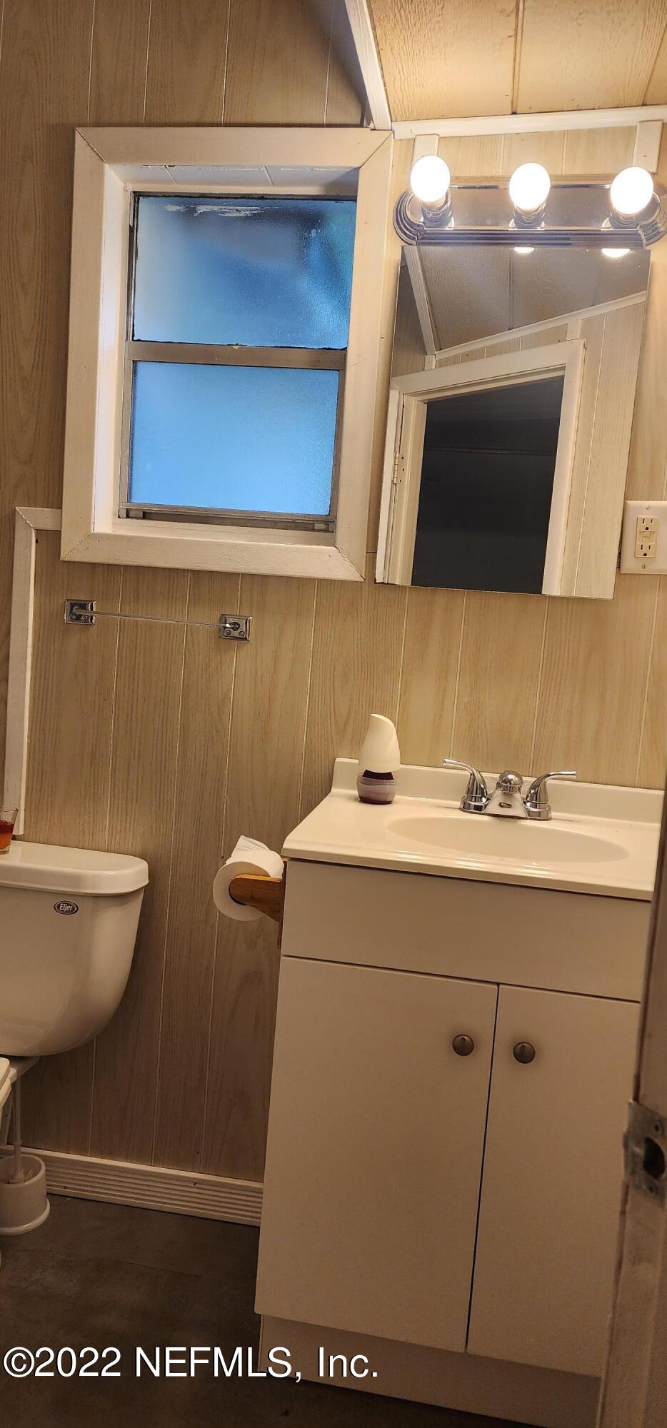25035 Northeast 131st Place Salt Springs, FL 32134 - Photo 12 of 21 a bathroom with a sink a toilet and mirror