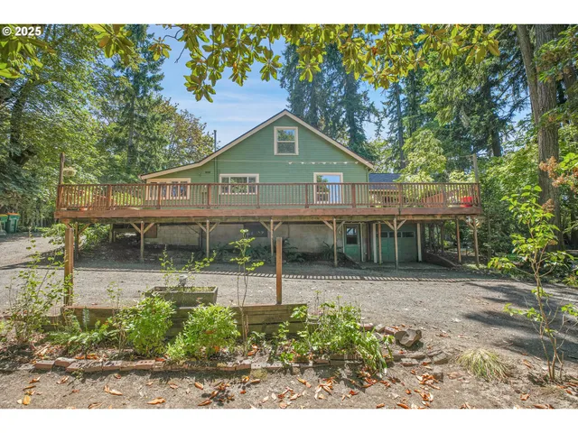 a front view of a house with a yard and potted plants