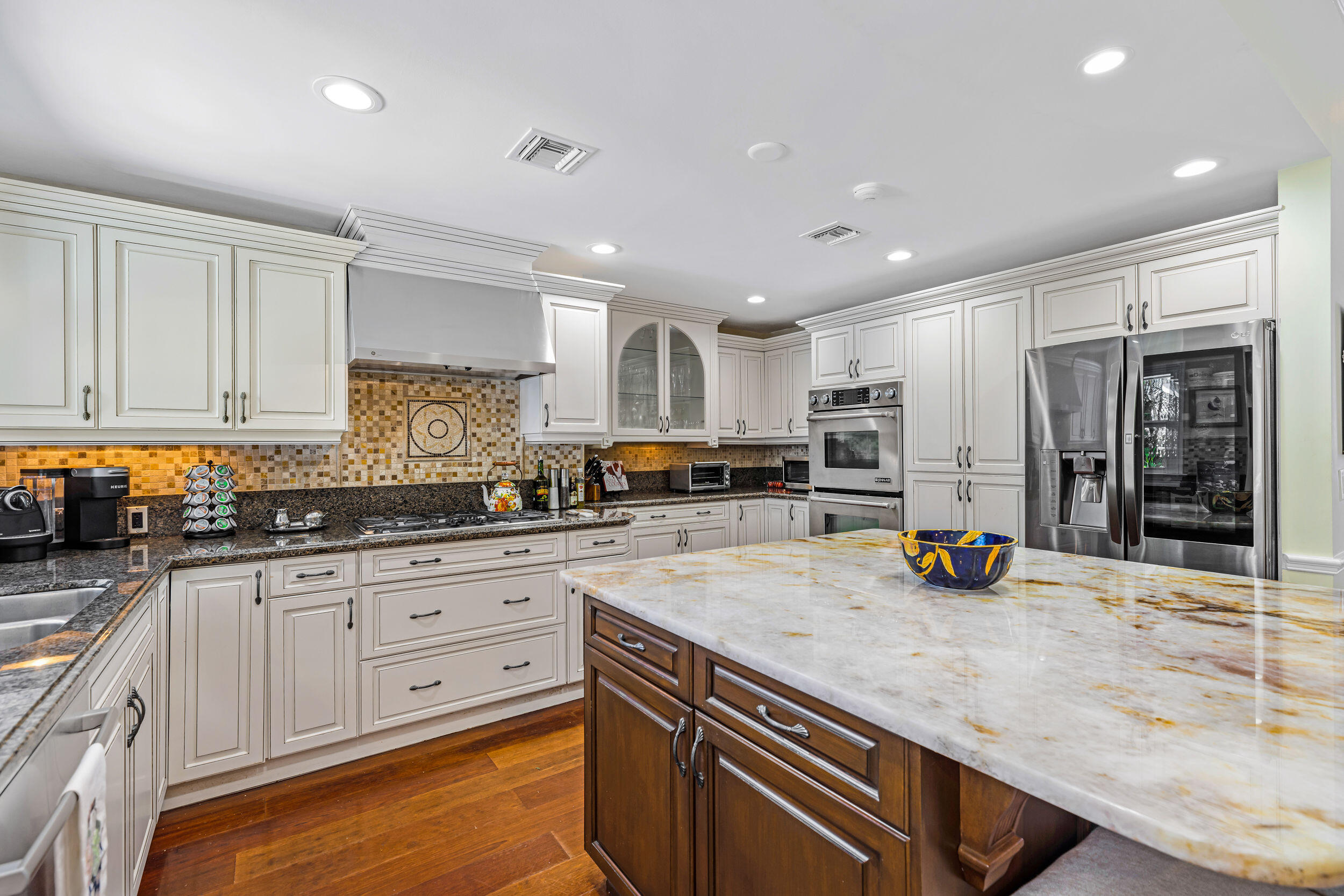 1310 Southwest 9th Avenue Boca Raton, FL 33486 - Photo 3 of 12 a kitchen with stainless steel appliances granite countertop a stove and cabinets