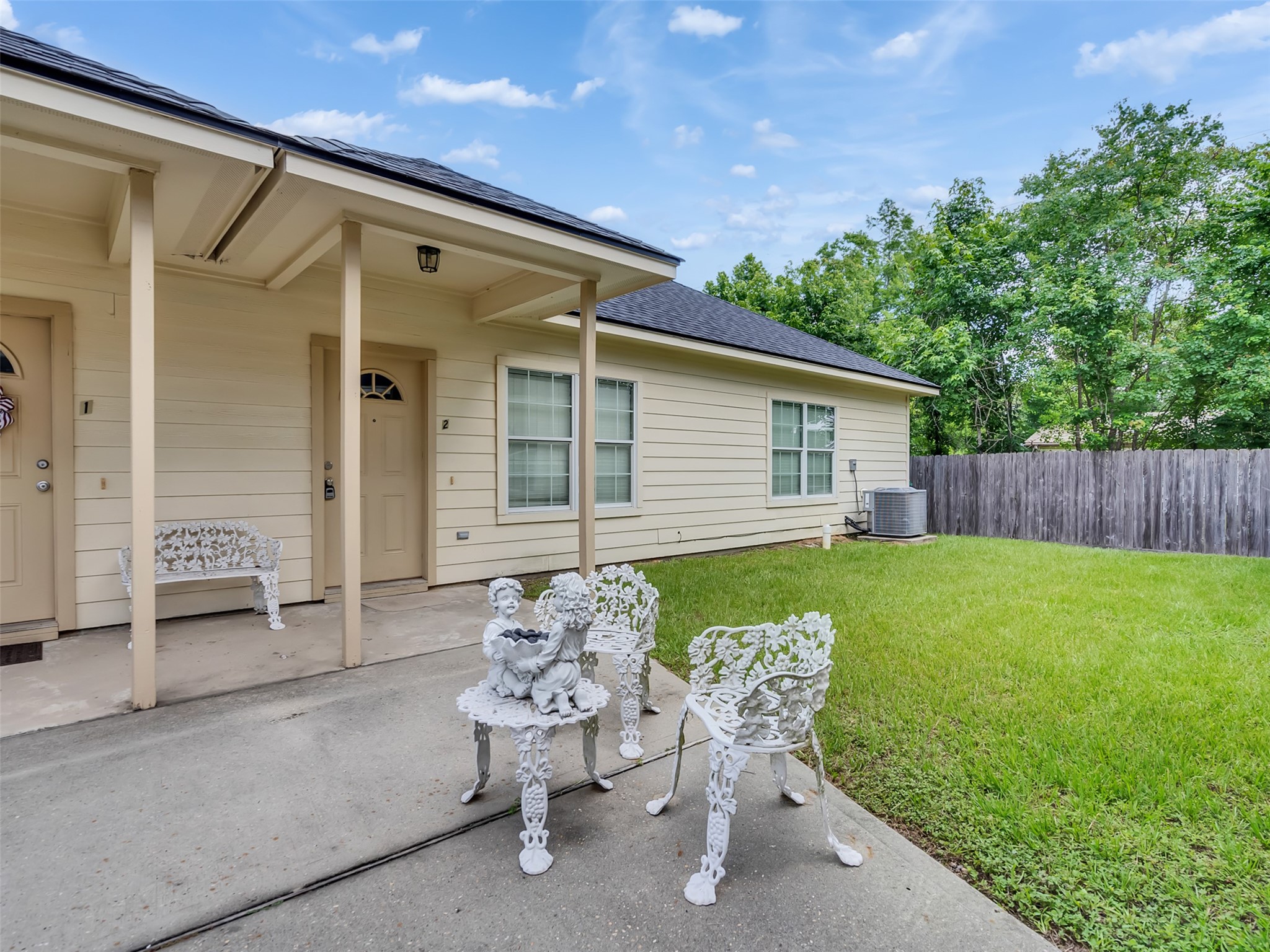 104 Longstreet Road, Unit 2 Willis, TX 77378 - Photo 2 of 26 a backyard of a house with table and chairs