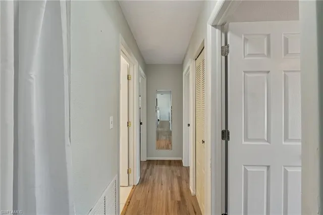 a view of a hallway with wooden floor