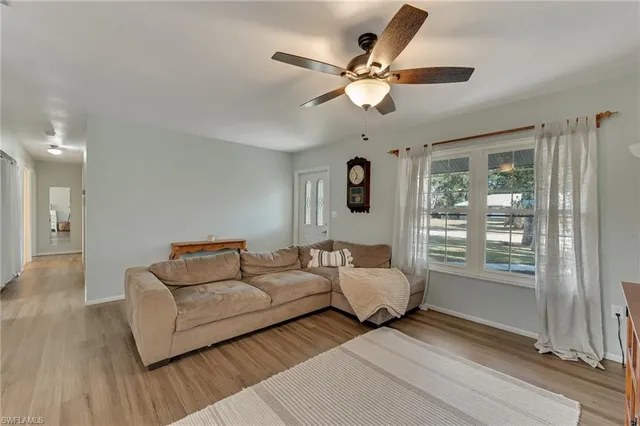 a living room with couches and furniture with wooden floor