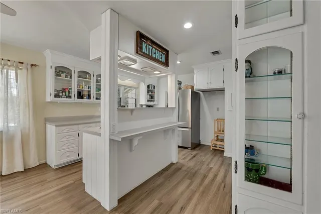 a open kitchen with white cabinets and stainless steel appliances