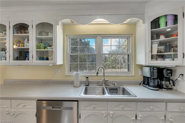 a kitchen with a sink and large window
