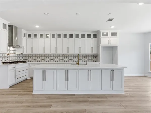 a kitchen with stainless steel appliances granite countertop a white cabinets and sink