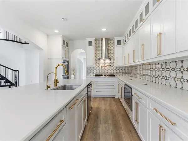 a kitchen with sink a stove and cabinets