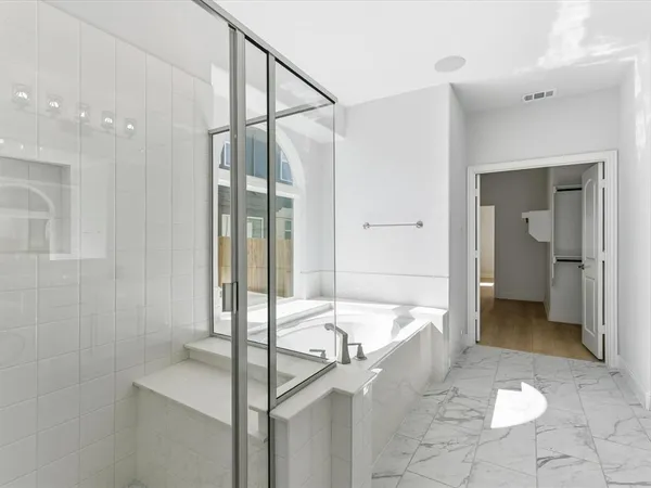 a large bathroom with a tub and shower