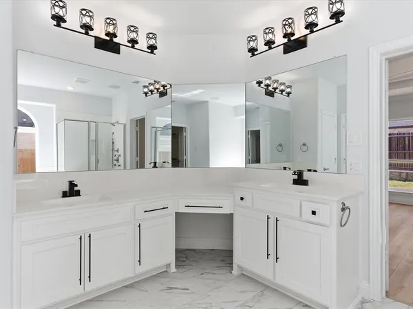 a spacious en suite bathroom with a double vanity sink