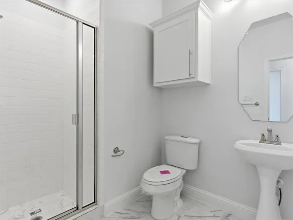 a white toilet sitting next to a bathroom sink