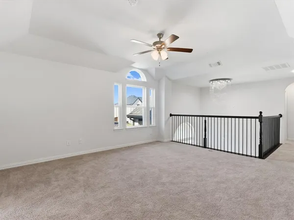 a view of a livingroom with a ceiling fan and window