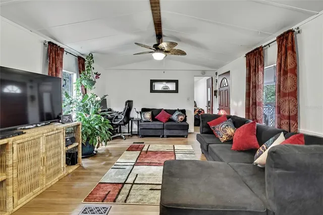 a living room with furniture and a flat screen tv