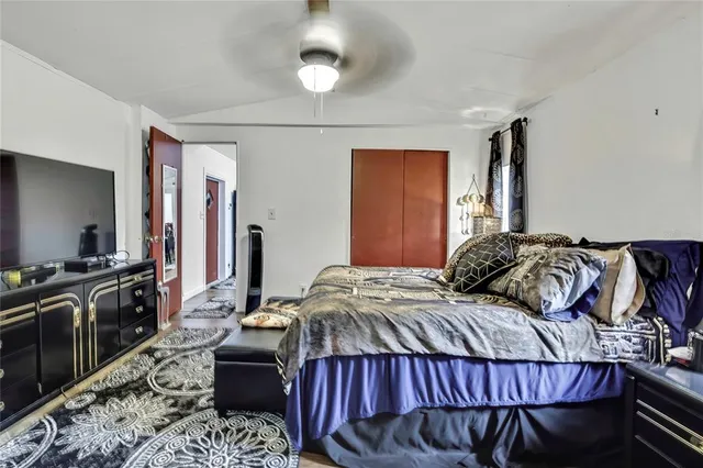 a bedroom with a bed and a flat screen tv