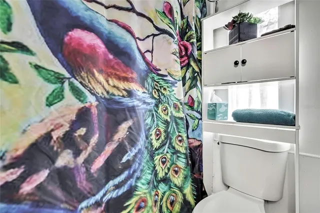 a bathroom with a sink toilet and mirror