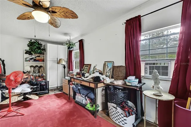 a view of a workspace with furniture and a window