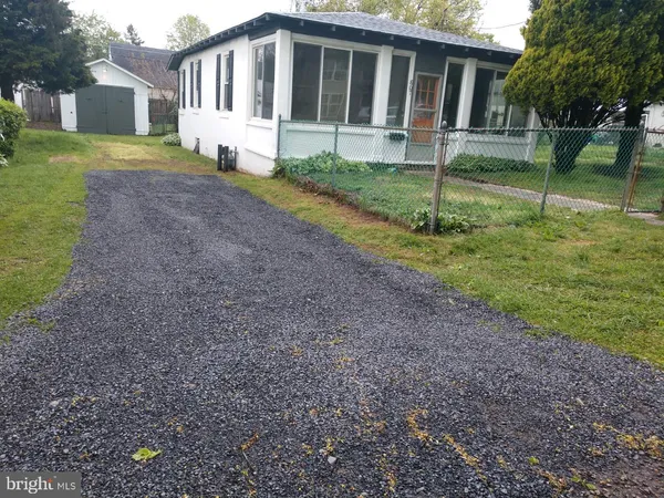 a view of house with a yard