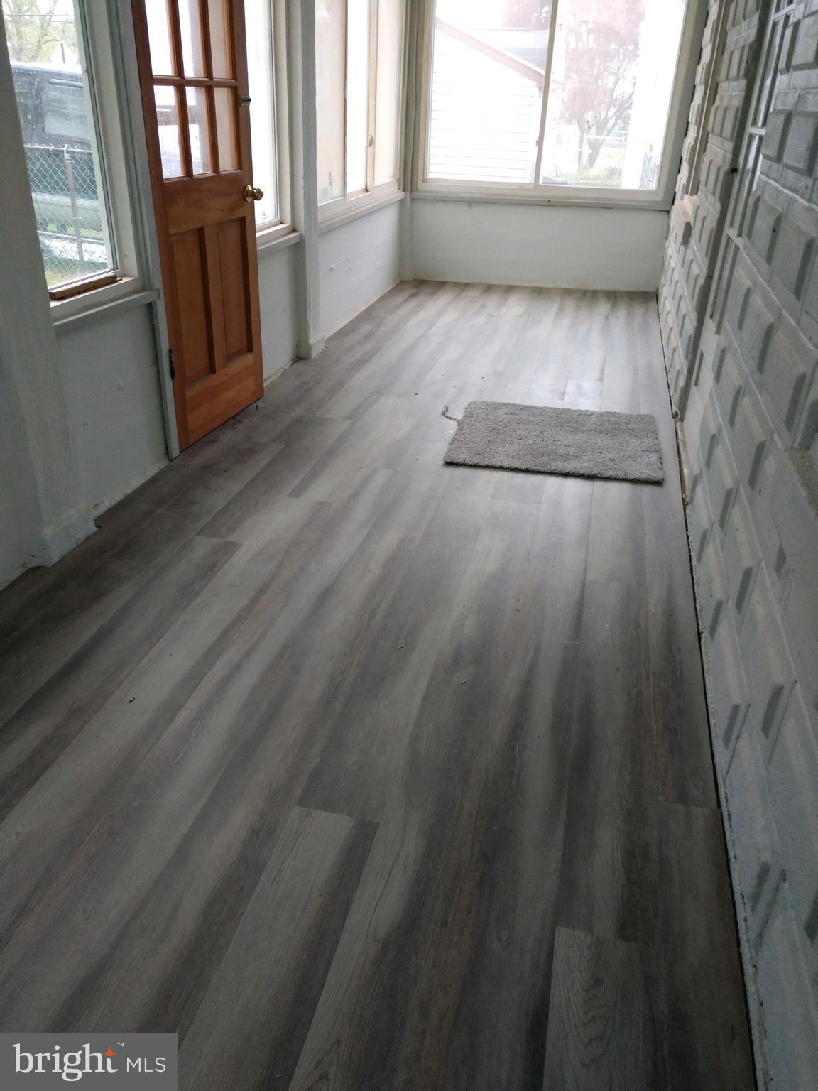 807 Merlin Street Bristol, PA 19007 - Photo 12 of 18 a view of an empty room with a window and wooden floor