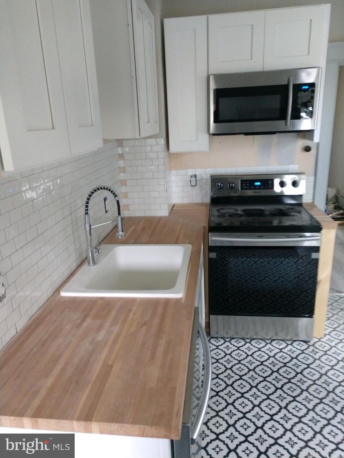 807 Merlin Street Bristol, PA 19007 - Photo 6 of 18 a kitchen with a sink and a stove top oven