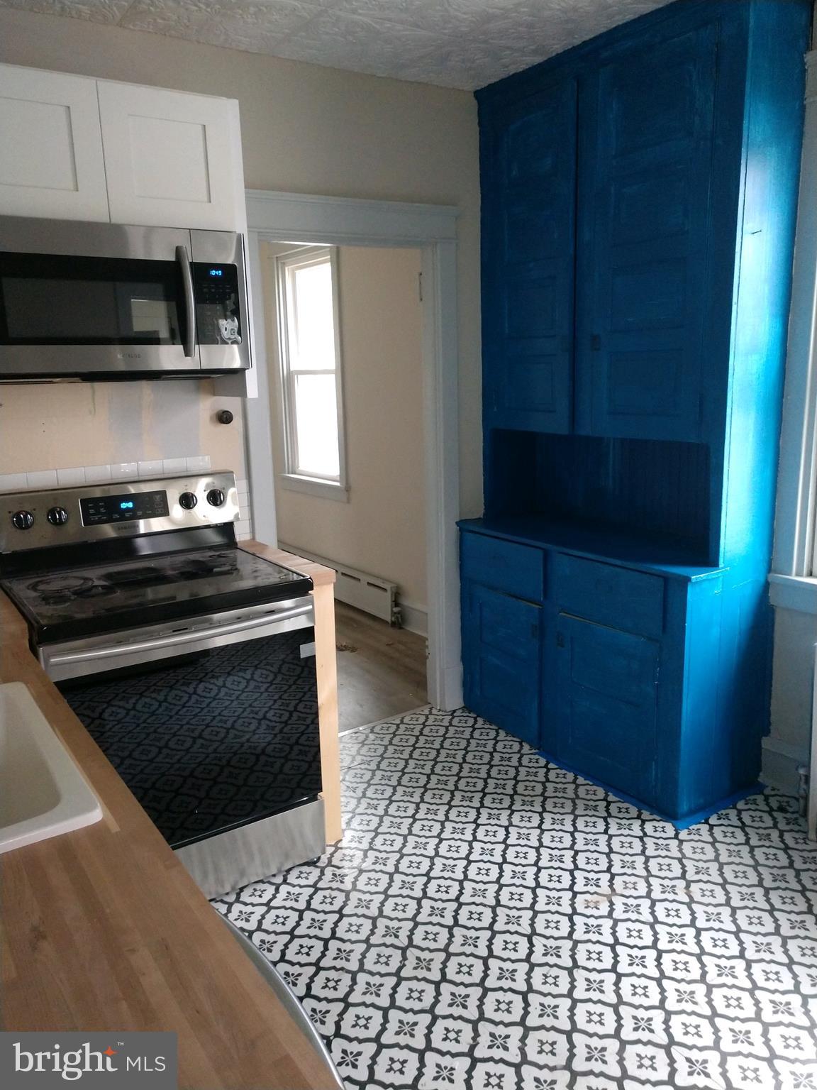 807 Merlin Street Bristol, PA 19007 - Photo 7 of 18 a kitchen with a stove and a microwave