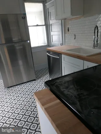 a close view of sink and cabinets