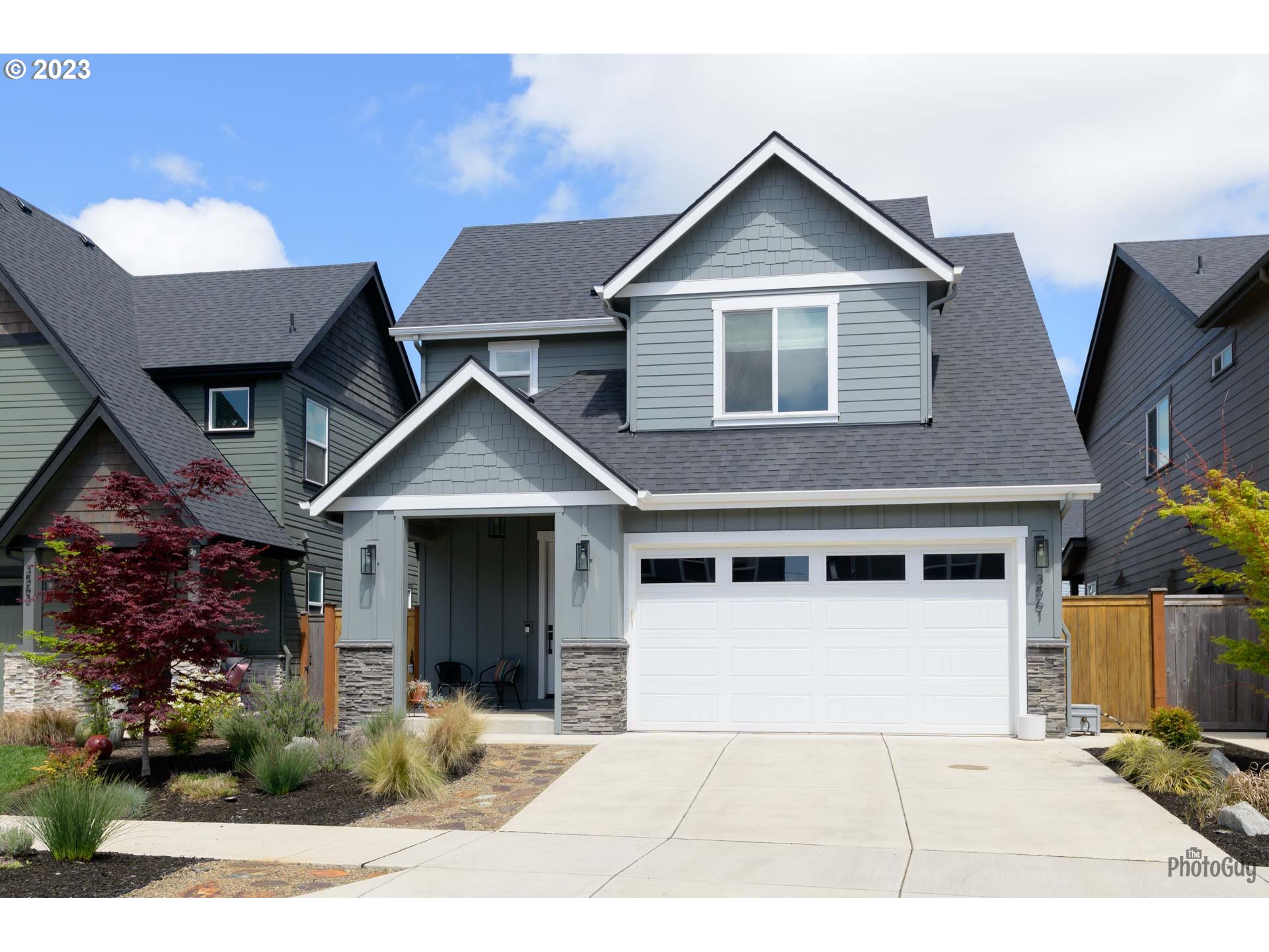 3561 Nestucca Loop Eugene, OR 97408 - Photo 2 of 29 a front view of a house with a yard and garage