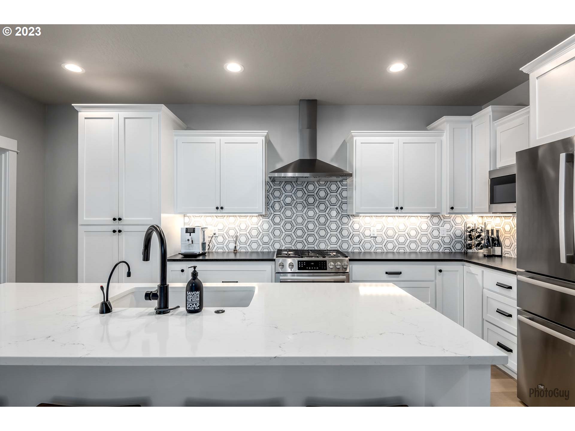 3561 Nestucca Loop Eugene, OR 97408 - Photo 5 of 29 a kitchen with stainless steel appliances granite countertop a sink a stove and a refrigerator