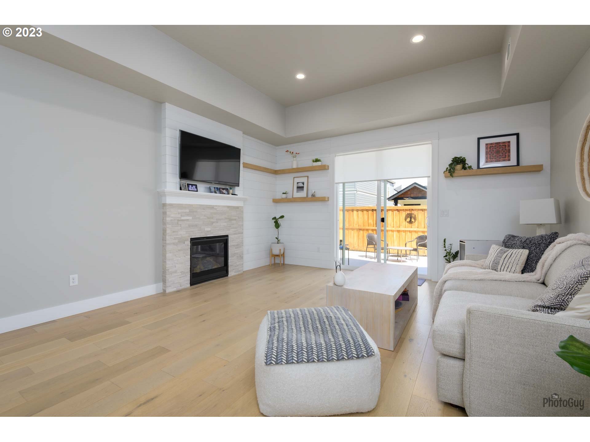 3561 Nestucca Loop Eugene, OR 97408 - Photo 9 of 29 a living room with furniture a fireplace and a flat screen tv