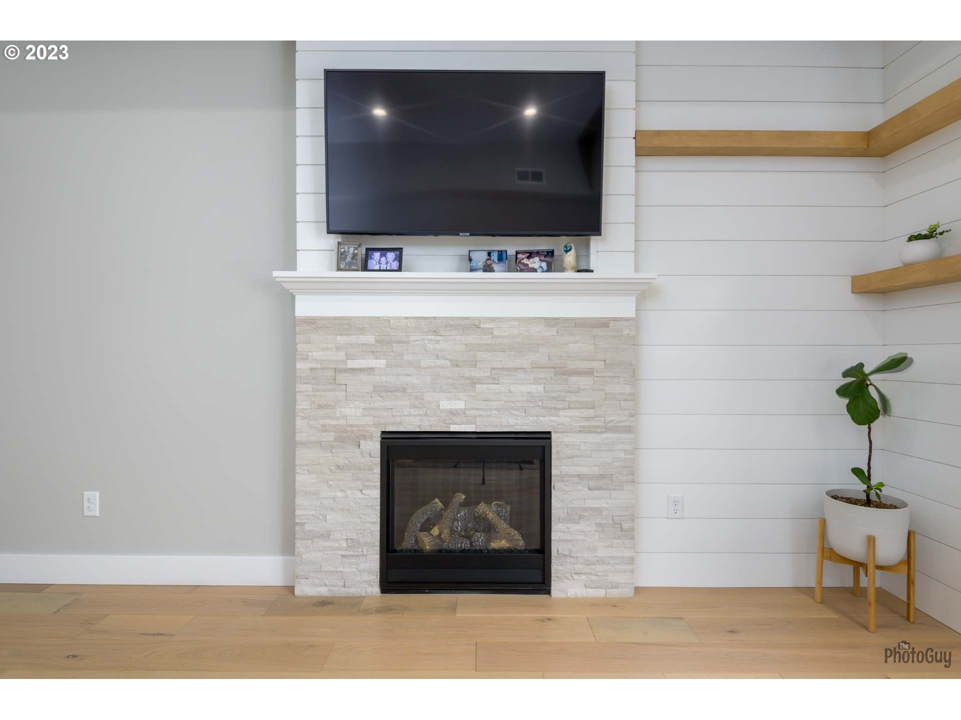 3561 Nestucca Loop Eugene, OR 97408 - Photo 10 of 29 a living room with a fireplace and a flat screen tv