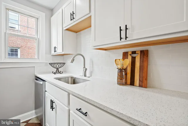 a kitchen with a sink and cabinets
