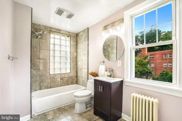 a bathroom with a sink toilet and tub