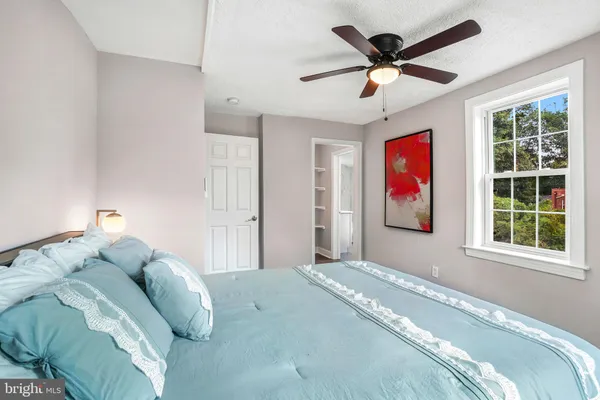 a bedroom with a bed and a window