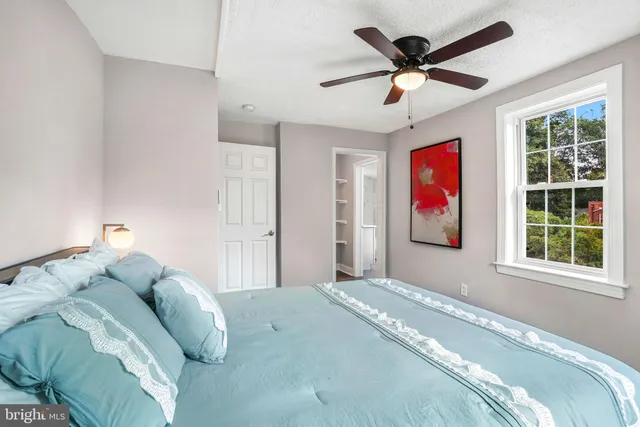 a bedroom with a bed and a window