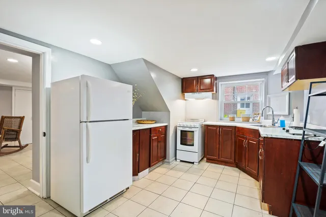 a kitchen with stainless steel appliances a refrigerator and a stove top oven