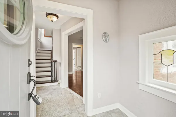 a view of a livingroom with furniture and staircase