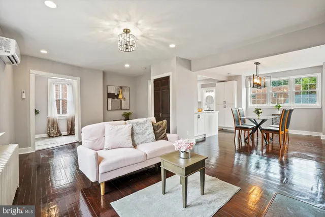 a living room with furniture and a chandelier