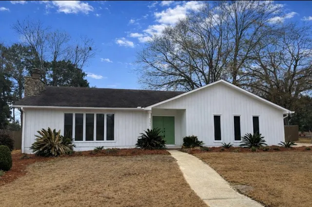 a view of a house with yard and a garden